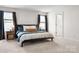 Spacious main bedroom with carpet, two windows with curtains, and a king bed with decorative pillows at 228 Brownstone Dr, Rock Hill, SC 29730