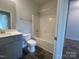 Modern bathroom features a tub/shower combo, gray vanity, toilet and black floor tiles at 228 Mountain Island Dr # 38, Statesville, NC 28677