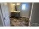 Bathroom boasts a double sink vanity, large mirror, black floor tiles and shower stall at 228 Mountain Island Dr # 38, Statesville, NC 28677