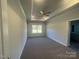 Bedroom features a tray ceiling, neutral walls, carpet, and bright light at 228 Mountain Island Dr # 38, Statesville, NC 28677