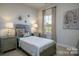 This bedroom features neutral walls, carpeted floors, and soft, filtered natural light from a nearby window at 228 Mountain Island Dr # 38, Statesville, NC 28677