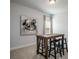 Cozy dining area with a table and seating, complemented by a modern art piece and natural light at 228 Mountain Island Dr # 38, Statesville, NC 28677