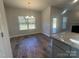 Dining room with hardwood floors and a modern light fixture, complemented by outdoor views at 228 Mountain Island Dr # 38, Statesville, NC 28677