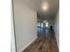 Hallway view that looks into a naturally lit living room area with hardwood floors and a fireplace at 228 Mountain Island Dr # 38, Statesville, NC 28677