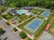 Aerial view showcases community amenities: pool, clubhouse, tennis courts, and playground at 2311 Lochview St, Pineville, NC 28134
