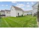 Well-maintained backyard featuring a lush lawn, black fencing and a covered walkway, perfect for relaxation and entertaining at 2311 Lochview St, Pineville, NC 28134