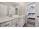 Bright bathroom with double sink vanity and view into main bedroom at 2311 Lochview St, Pineville, NC 28134