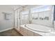 Bright bathroom with separate tub and shower; natural light from large window at 2311 Lochview St, Pineville, NC 28134