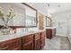 Bright bathroom features wood cabinets, double sinks, and a walk-in closet at 2311 Lochview St, Pineville, NC 28134