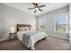 Neutral bedroom features two windows, ceiling fan, and comfortable furnishings at 2311 Lochview St, Pineville, NC 28134