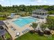 Aerial view of a pristine community pool area with multiple pools, lounge chairs, and manicured landscaping at 2311 Lochview St, Pineville, NC 28134