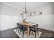 Bright dining room with wainscoting, stylish light fixture, and seating for six at 2311 Lochview St, Pineville, NC 28134