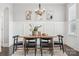 Modern dining area featuring natural wood table, seating, and decorative lighting at 2311 Lochview St, Pineville, NC 28134