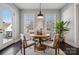 Cozy dining area with a round table, four chairs, a stylish pendant light and a door to the outside at 2311 Lochview St, Pineville, NC 28134