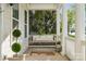 Inviting front porch with swing, white columns, and lush landscaping at 2311 Lochview St, Pineville, NC 28134