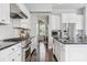 Bright kitchen featuring white cabinets, stainless steel appliances, and dark hardwood flooring at 2311 Lochview St, Pineville, NC 28134