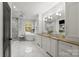 This bright bathroom features double sinks, granite countertops, and a large soaking tub at 2500 Giverny Dr, Charlotte, NC 28226