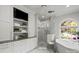 Elegant bathroom with a soaking tub next to a window and a glass enclosed shower at 2500 Giverny Dr, Charlotte, NC 28226