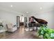 Elegant living room features hardwood floors, a baby grand piano, and refined details at 2500 Giverny Dr, Charlotte, NC 28226