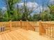 New back deck and stairs, surrounded by a wooden fence and tree line at 2501 Elon St, Charlotte, NC 28208