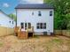Home backyard, showing a new deck with stairs, white siding, and a new fence at 2501 Elon St, Charlotte, NC 28208