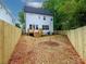 View of the backyard, showcasing new wooden fence, and deck off of the home's back at 2501 Elon St, Charlotte, NC 28208