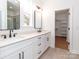 Bright bathroom featuring double vanity with modern fixtures and a walk-in closet at 2501 Elon St, Charlotte, NC 28208