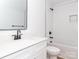 Clean bathroom featuring white vanity, subway tile, black hardware, and a tub with shower at 2501 Elon St, Charlotte, NC 28208