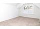 Bright bedroom with neutral carpeting and dormer window offering plenty of natural light at 2501 Elon St, Charlotte, NC 28208