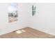 This bedroom offers natural light with two windows and beautiful wood-look vinyl floors at 2501 Elon St, Charlotte, NC 28208
