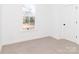 Cozy bedroom featuring soft carpeting and a window that brings in natural light at 2501 Elon St, Charlotte, NC 28208