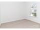 Bright bedroom with a large window, neutral carpet and fresh paint, perfect for relaxation at 2501 Elon St, Charlotte, NC 28208