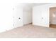 Spacious bedroom featuring soft carpet, white doors, and an ensuite bathroom at 2501 Elon St, Charlotte, NC 28208