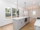 Spacious kitchen with white countertops, a kitchen island and wood flooring at 2501 Elon St, Charlotte, NC 28208