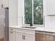 Bright kitchen features white cabinets, stainless steel appliances, and a window over the sink at 2501 Elon St, Charlotte, NC 28208