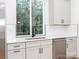 Bright kitchen features white cabinets, stainless steel appliances, and a window over the sink at 2501 Elon St, Charlotte, NC 28208