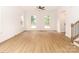 Open living area with neutral walls, hardwood floors, ceiling fan, and bright natural light at 2501 Elon St, Charlotte, NC 28208