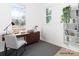 A bright office features vinyl floors, two windows, and custom shelving at 2501 Elon St, Charlotte, NC 28208