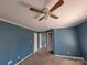 Spacious blue bedroom with ceiling fan and view into another room at 2527 Carya Pond Ln, Charlotte, NC 28212