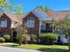 Brick exterior of a two-story townhome with a second-floor balcony and manicured landscaping at 2527 Carya Pond Ln, Charlotte, NC 28212