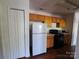 Compact kitchen with wood cabinets, black appliances, and ample counter space adjacent to a pantry at 2527 Carya Pond Ln, Charlotte, NC 28212