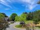 View of street with parked cars and green trees at 2527 Carya Pond Ln, Charlotte, NC 28212