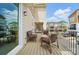 Cozy balcony with sliding glass door, outdoor seating, and relaxing view of the neighborhood homes and blue skies at 2533 Ensemble Ct, Charlotte, NC 28262