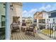 A relaxing balcony featuring a wood floor, black metal railing, and outdoor furniture with great views of the community at 2533 Ensemble Ct, Charlotte, NC 28262