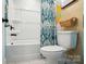 Well-lit bathroom featuring a shower-tub combination with stylish shower curtain and decor at 2533 Ensemble Ct, Charlotte, NC 28262