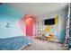 Stylish bedroom featuring colorful design, a tv, ample lighting and comfortable desk at 2533 Ensemble Ct, Charlotte, NC 28262