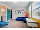 Bonus room featuring playful wall art, desk space, and a comfortable blue couch at 2533 Ensemble Ct, Charlotte, NC 28262