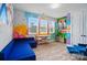 Playful bonus room with wood floors, graffiti-inspired walls, a blue couch, and a desk at 2533 Ensemble Ct, Charlotte, NC 28262