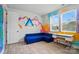 Bonus room with playful wall art, desk space, blue couch, and plenty of natural light at 2533 Ensemble Ct, Charlotte, NC 28262