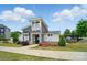 Well-maintained community clubhouse with stone and gray siding, beautiful landscaping, and manicured lawn at 2533 Ensemble Ct, Charlotte, NC 28262